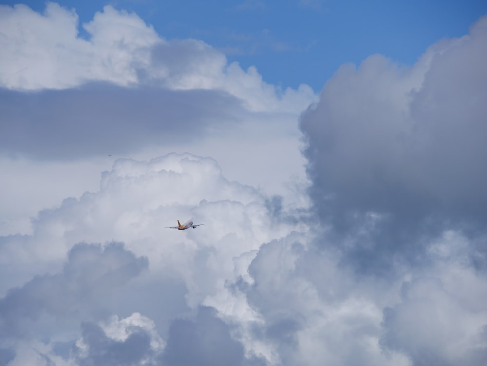 a plane is flying through the clouds in the sky