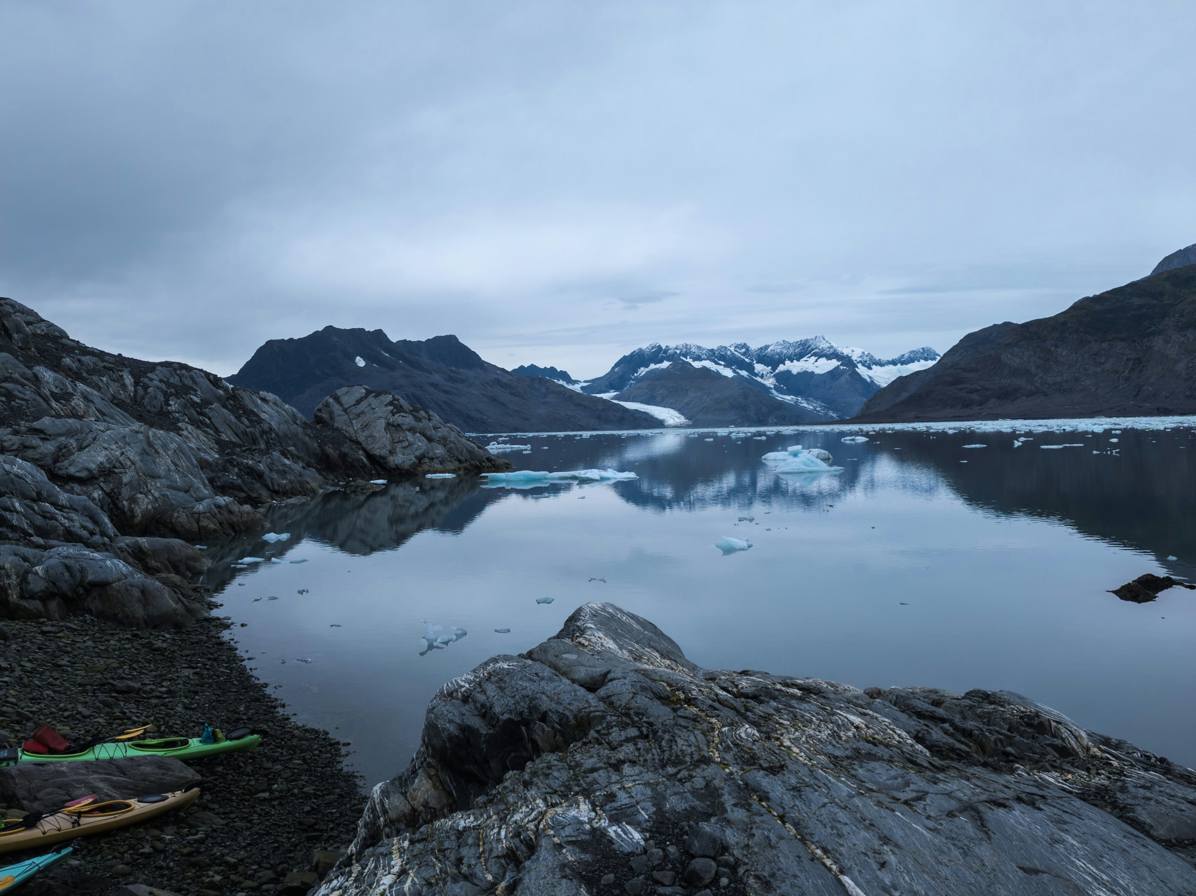 a body of water surrounded by mountains and ice