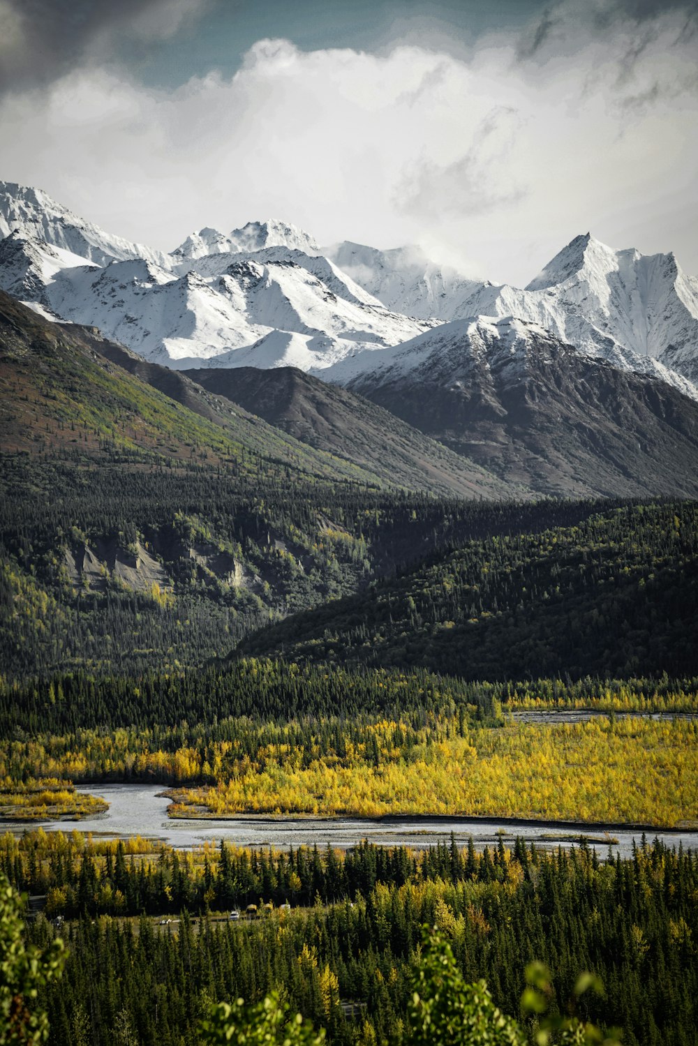 a view of a mountain range with a river in the foreground