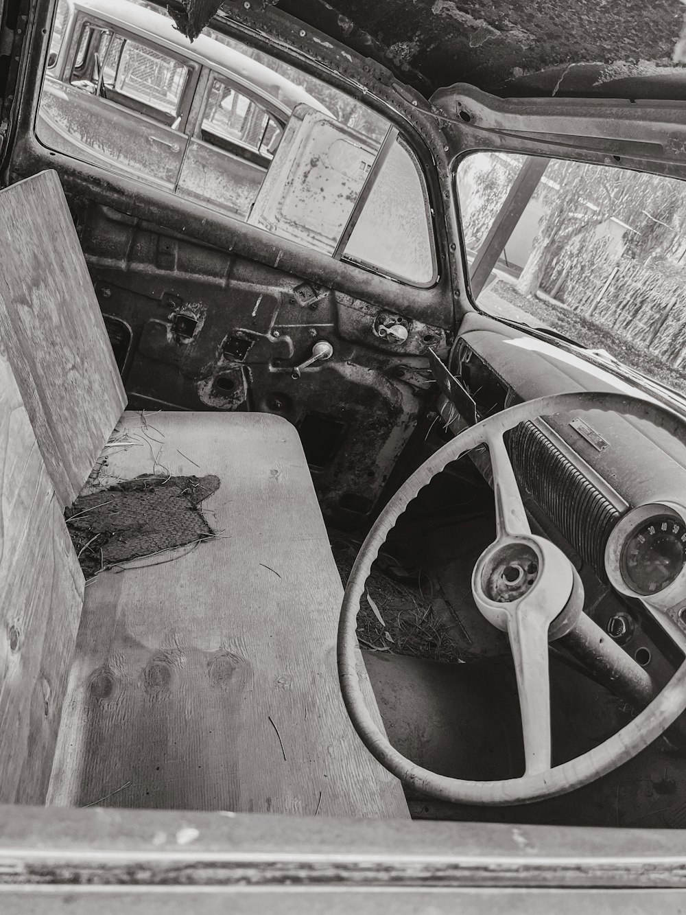 an old truck with a steering wheel and dashboard