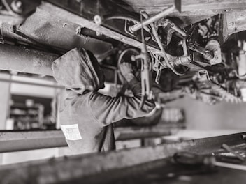 A mechanic working on a vehicle in a garage.