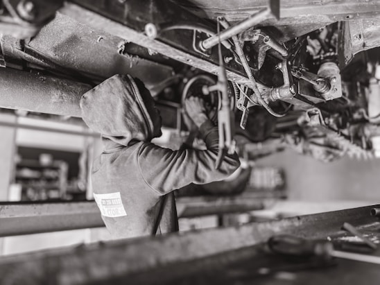A skilled mechanic working on a vehicle in a mobile workshop.