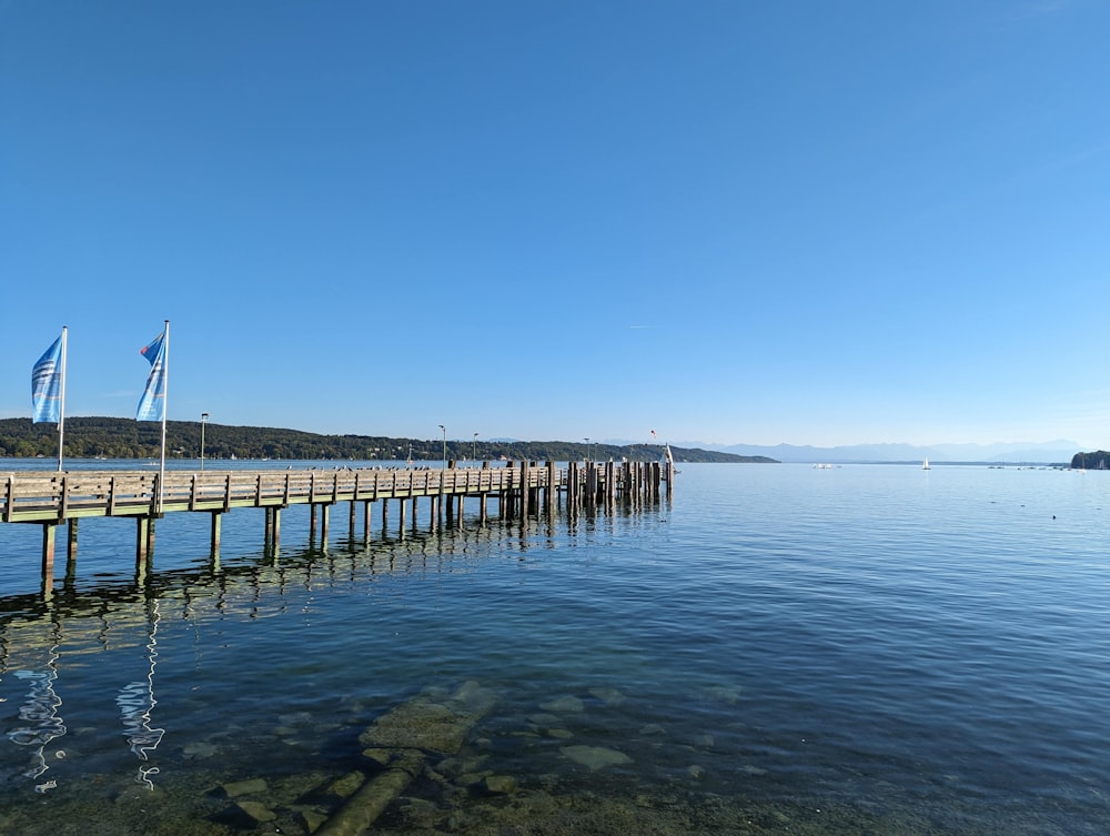 a long wooden pier sitting next to a body of water