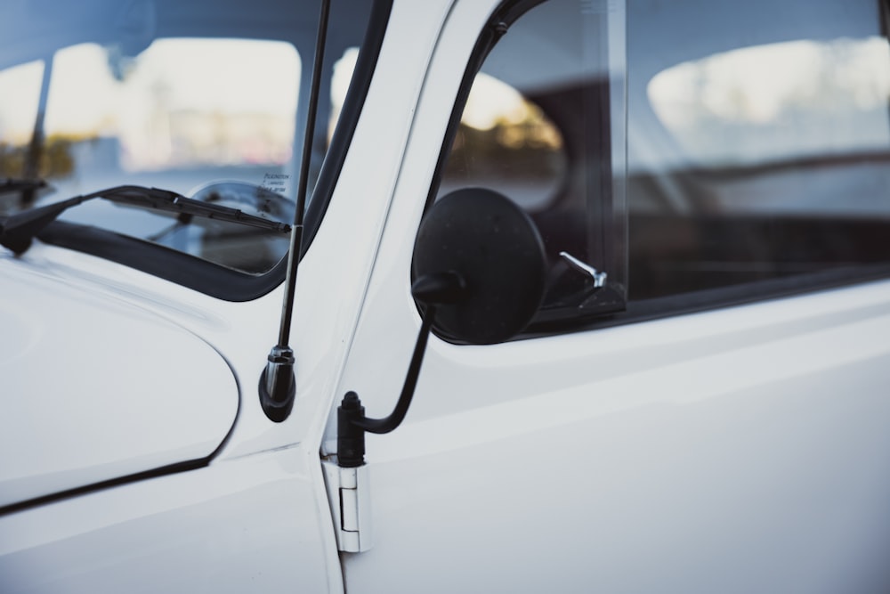 a close up of the side mirror of a white truck