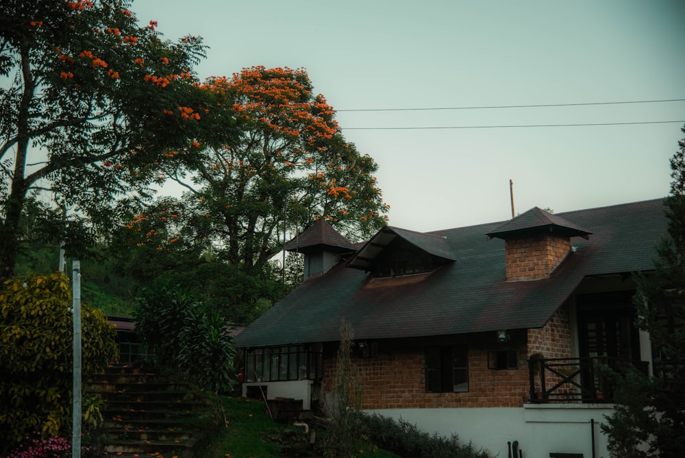 a house with a black roof and a steeple