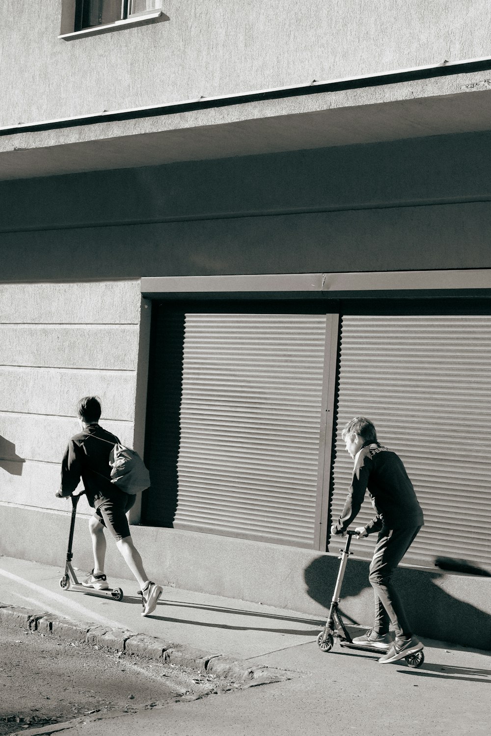 a black and white photo of a man riding a skateboard