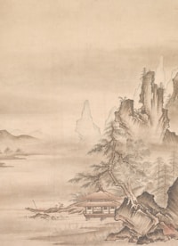 A traditional Asian landscape painting featuring a serene setting with a thatched-roof house nestled among rocky cliffs and sparse trees. Mist partially obscures the background, conveying a sense of tranquility and depth. The composition includes gently cascading rocks and finely detailed foliage.