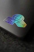 a close up of a laptop with a sticker on it
