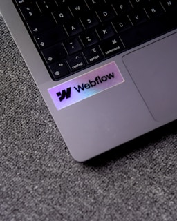 a close up of a laptop with a sticker on it