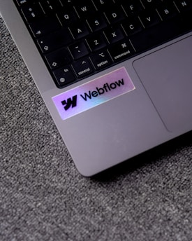 a close up of a laptop with a sticker on it