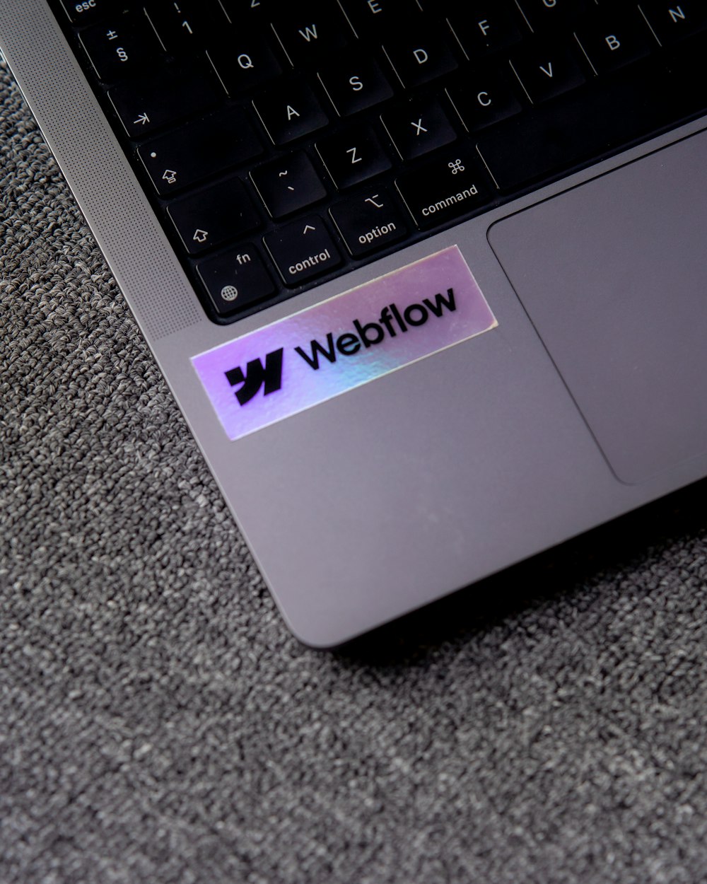 a close up of a laptop with a sticker on it