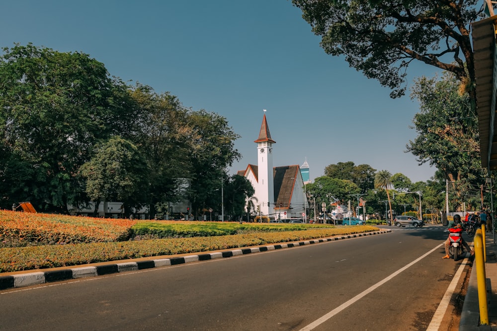 a long road with a church in the background