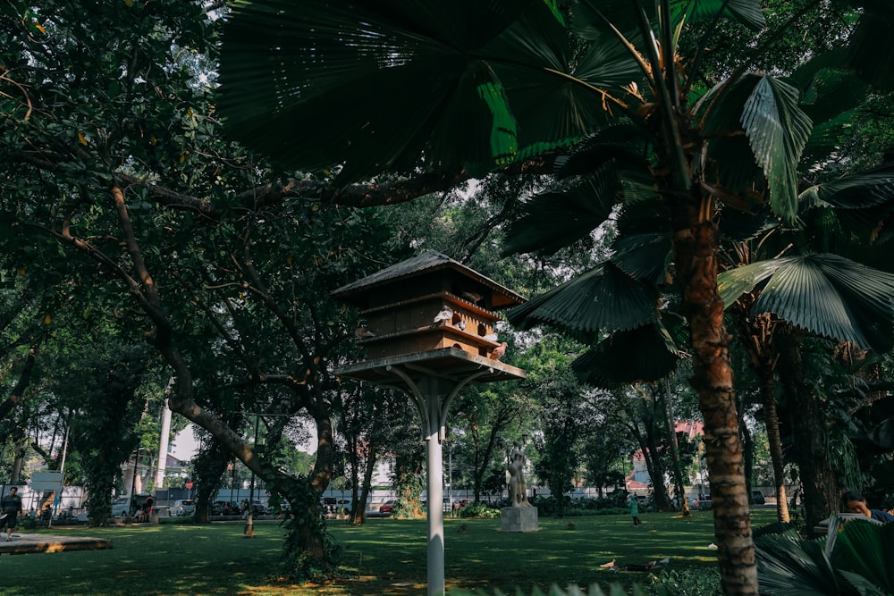 a bird house in the middle of a park