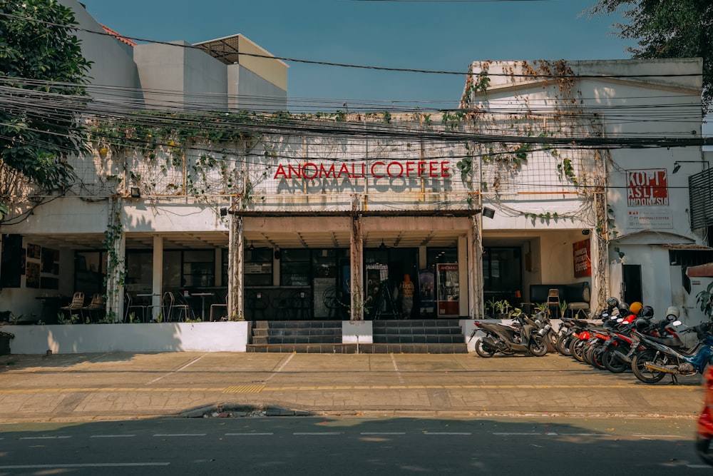 a group of motorcycles parked in front of a coffee shop