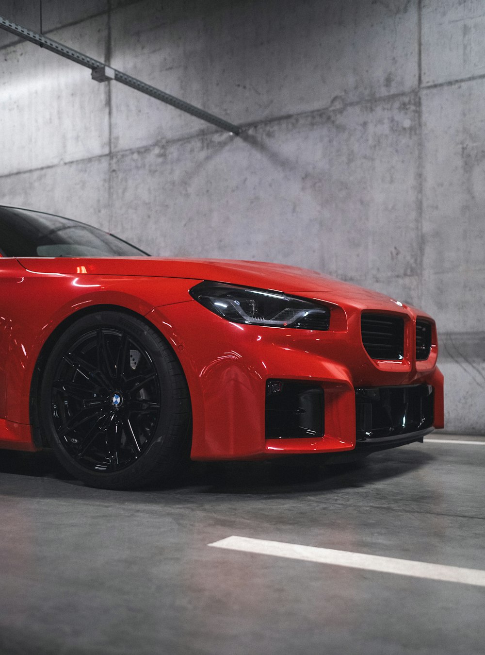 a red sports car parked in a parking garage