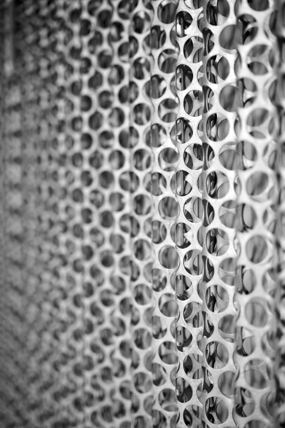 a black and white photo of a wall with circles on it
