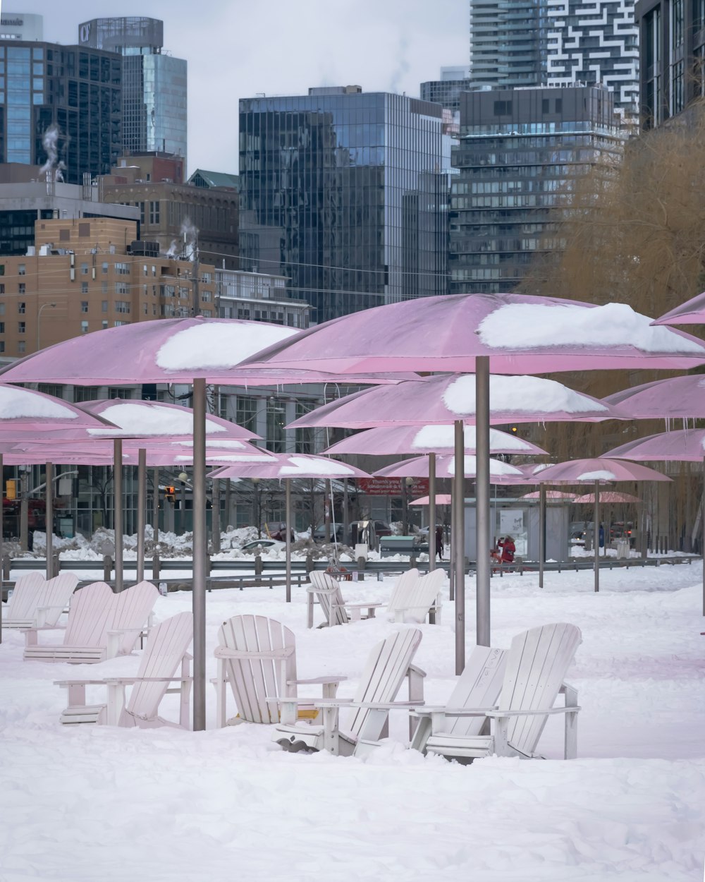 a bunch of chairs that are covered in snow