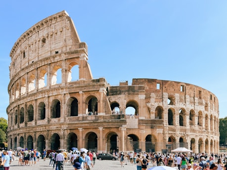 a group of people standing in front of an old building