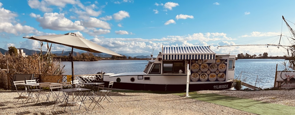 a boat is docked on the shore of a lake