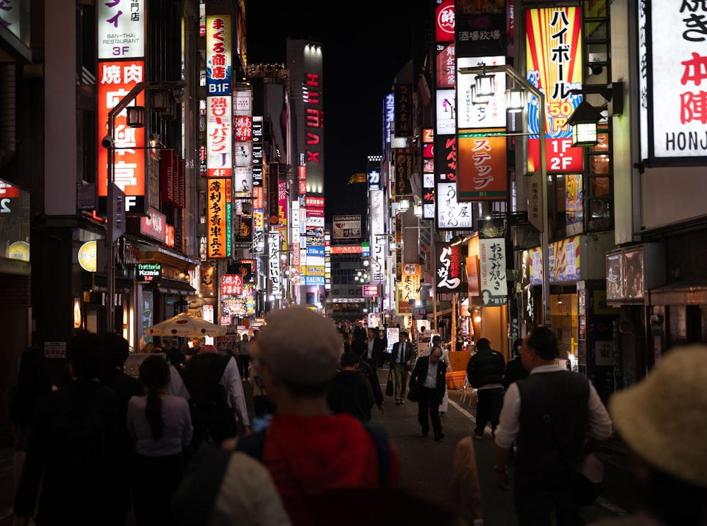 a city street filled with lots of neon signs