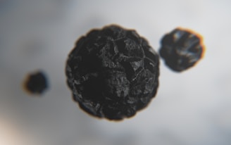 Close-up of black peppercorns and nutmeg highlighting their natural textures.