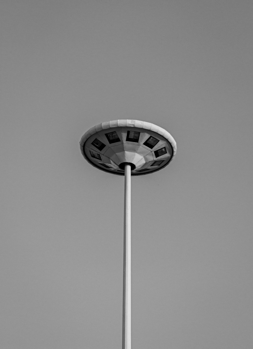 a black and white photo of a street light