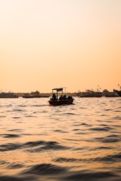 a small boat floating on top of a large body of water