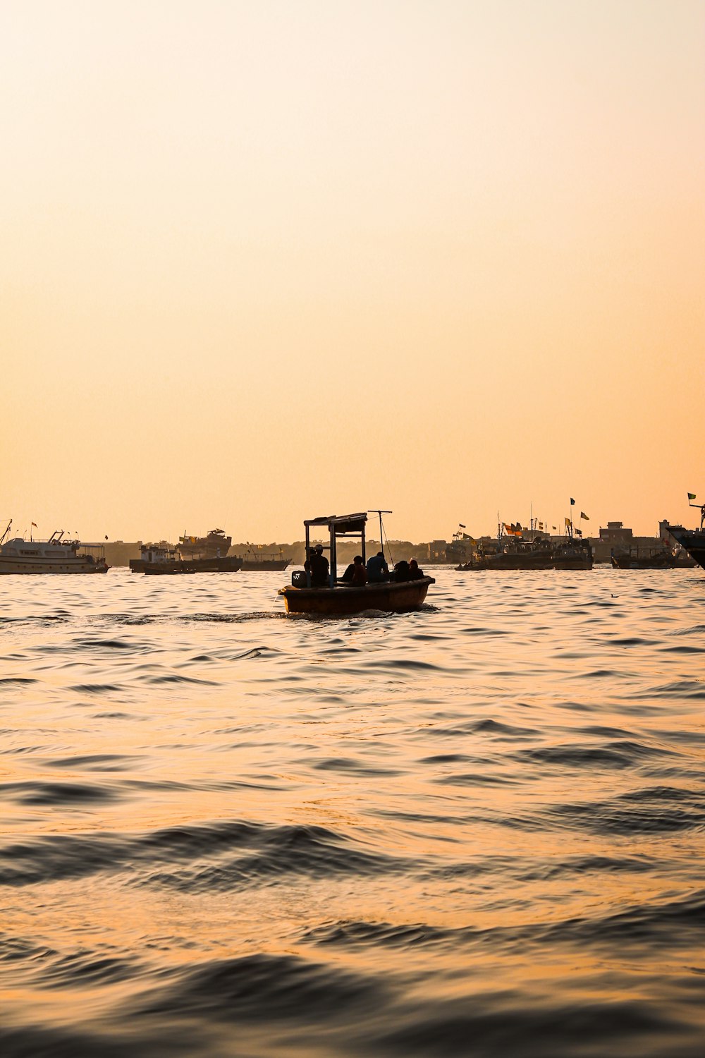 a small boat floating on top of a large body of water