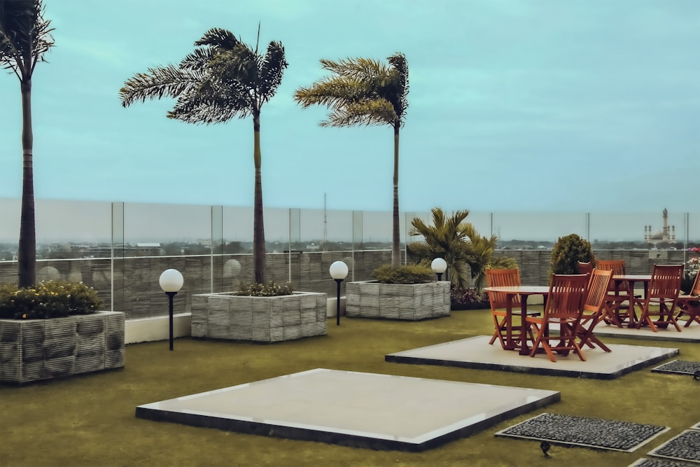 a group of chairs sitting on top of a lush green field