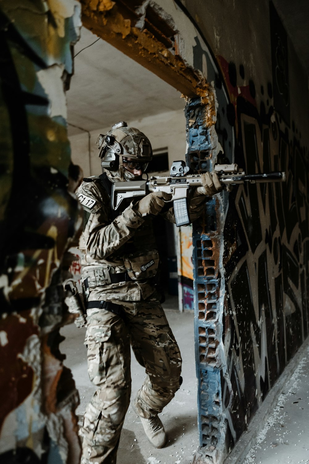 a man in camouflage holding a machine gun