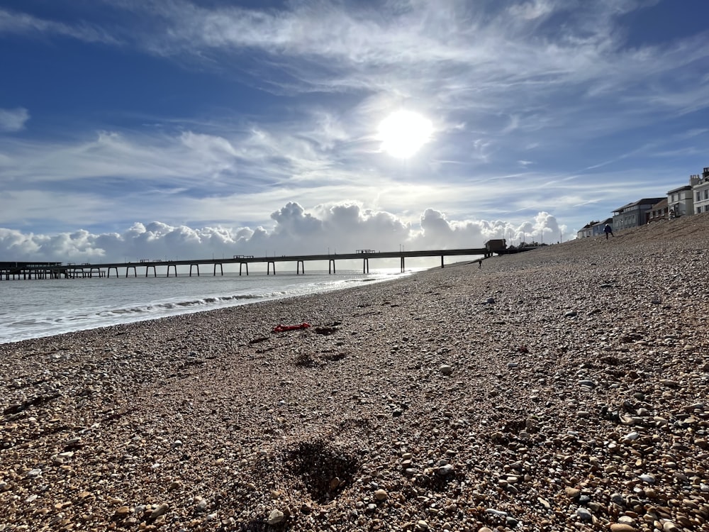 a beach with a pier in the background