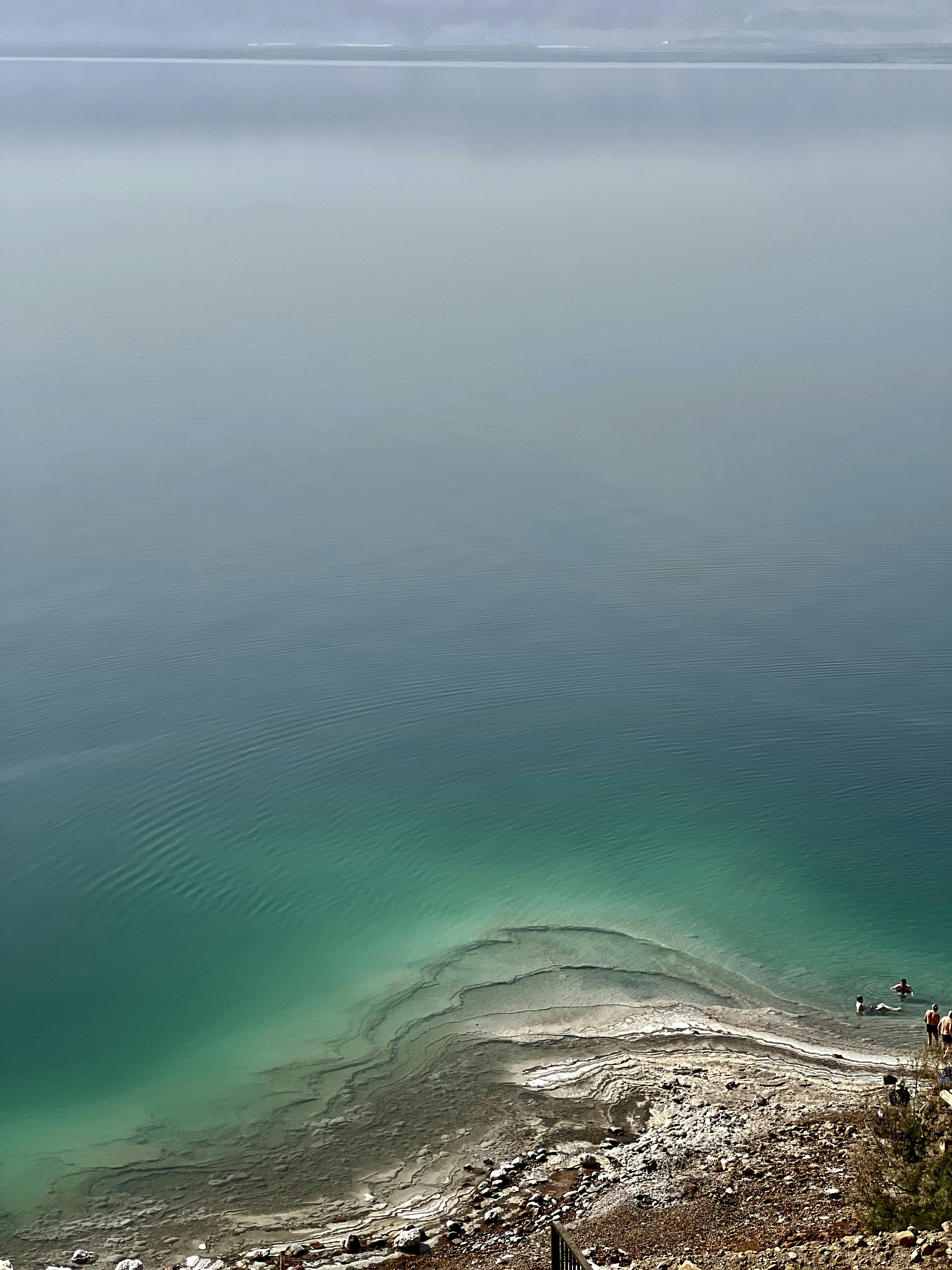 a large body of water with people swimming in it