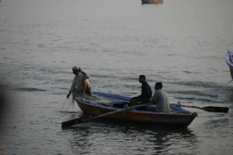 Florjan Gjoni guiding a small group while fishing on the boat at sunrise.