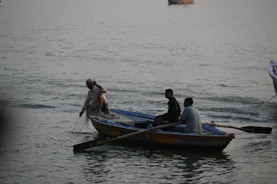 Florjan Gjoni guiding a small group while fishing on the boat at sunrise.