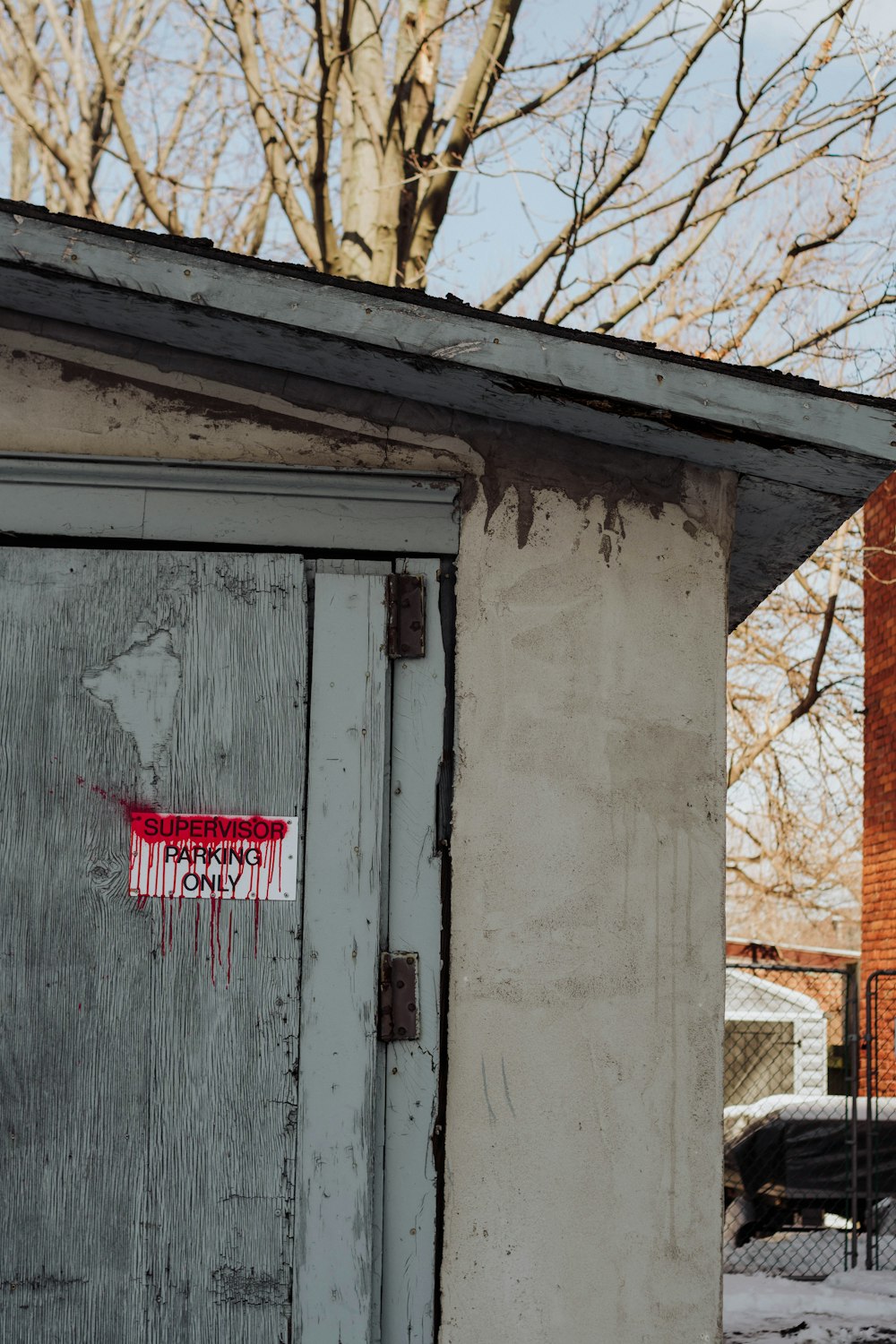 an outhouse with a red marker on the door