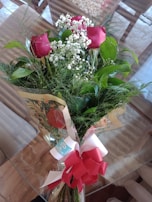 Elegant red roses bouquet wrapped in soft beige paper with a satin ribbon.