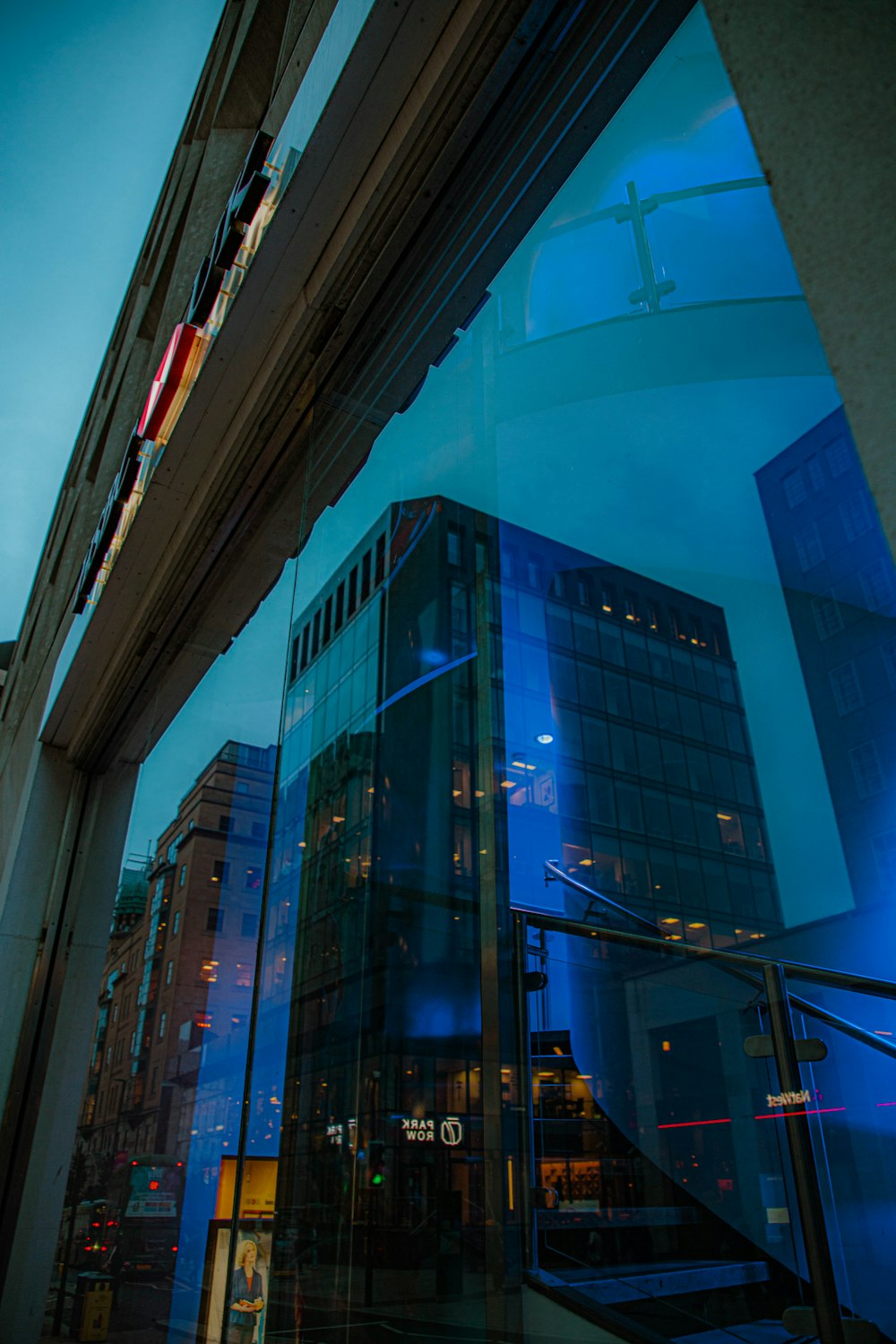 a building is reflected in a glass window