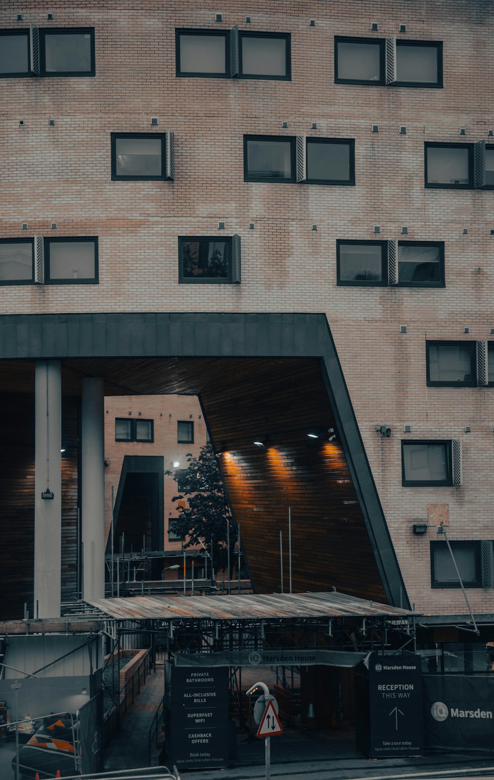 a tall building with lots of windows next to a street