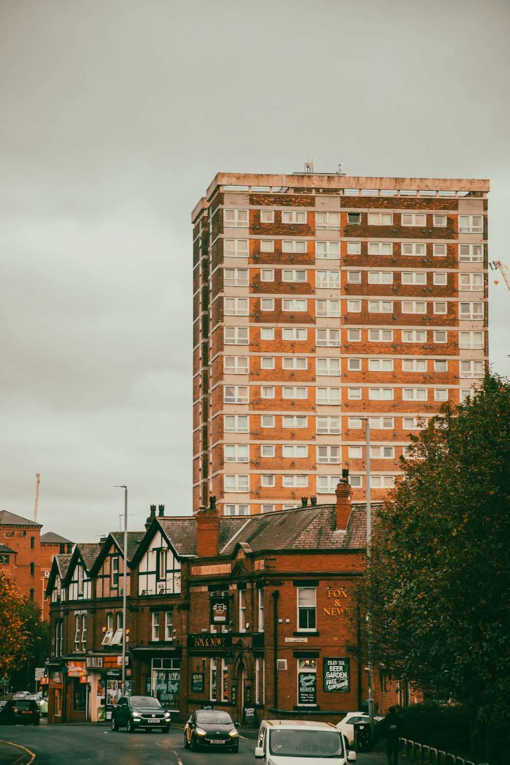 a tall brick building sitting on the side of a road