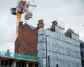 a crane is on top of a building under construction
