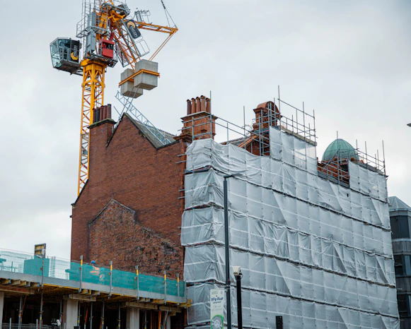 a crane is on top of a building under construction