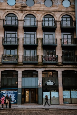 Md Nur Alam warmly greeting clients outside a classic New York City brownstone.