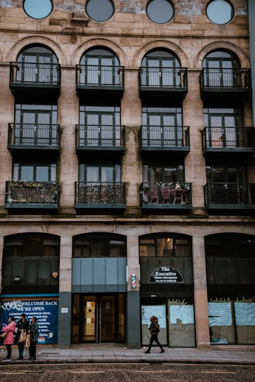 Md Nur Alam warmly greeting clients outside a classic New York City brownstone.