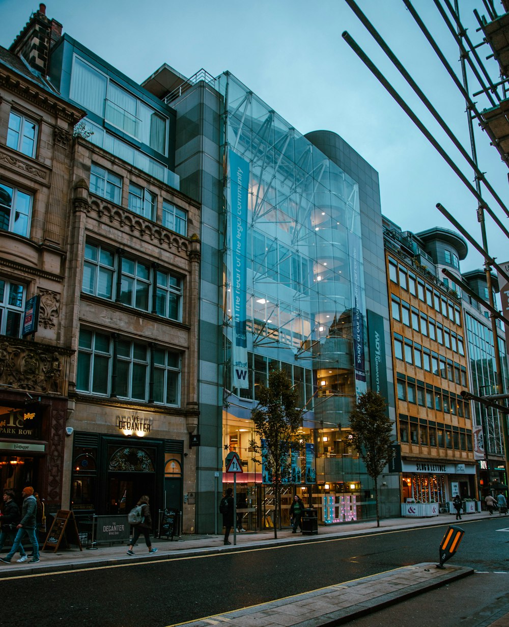 a large glass building sitting on the side of a street