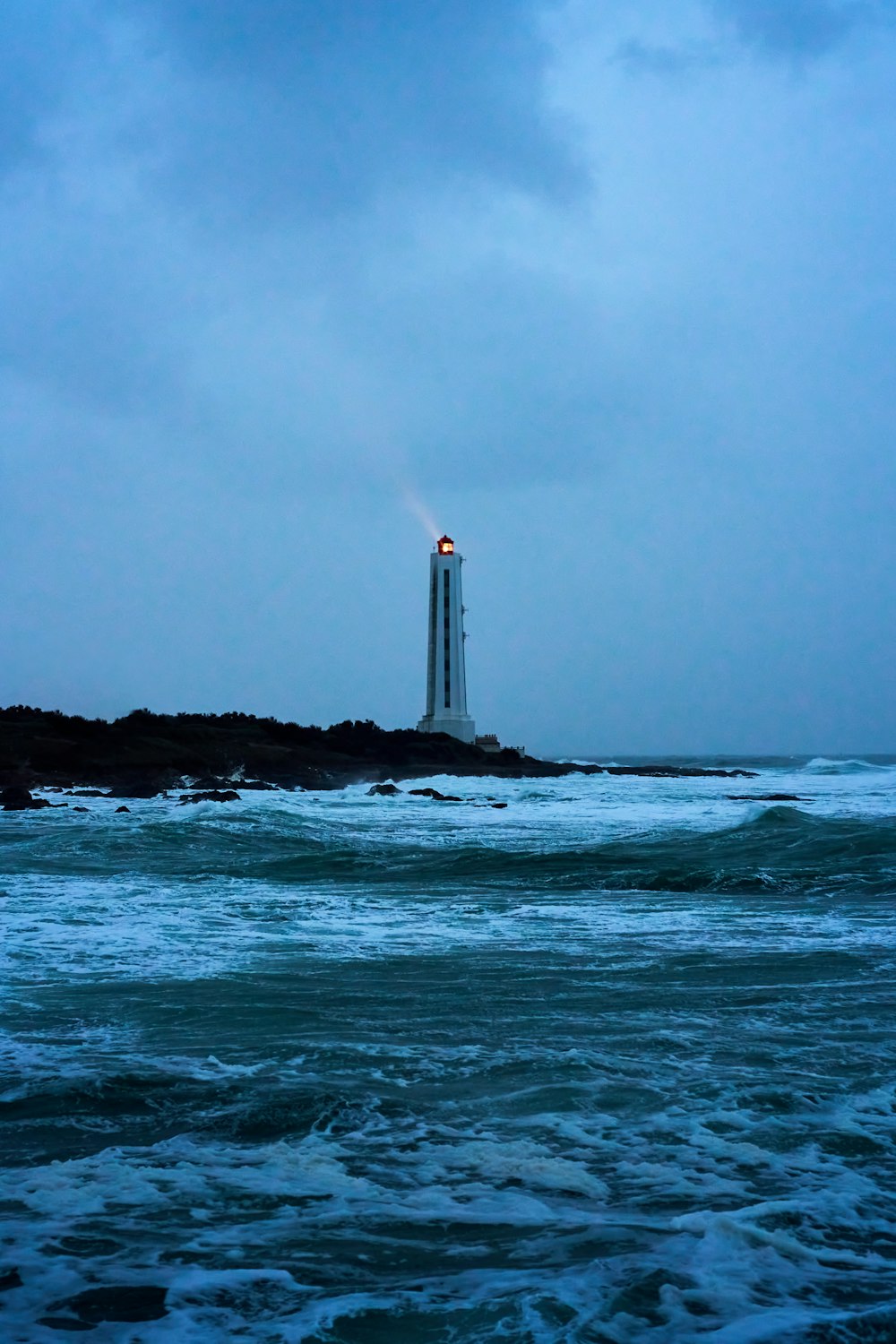 a light house sitting on top of a small island