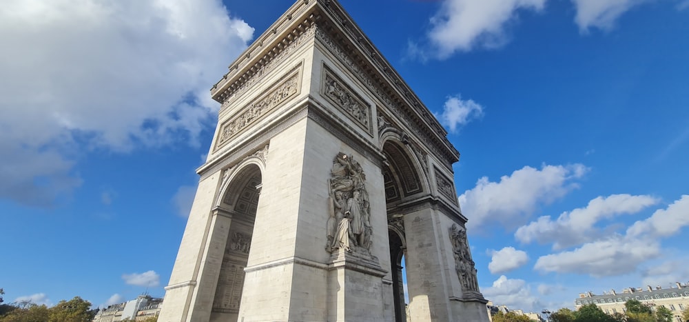 a very tall white monument with a clock on it's side