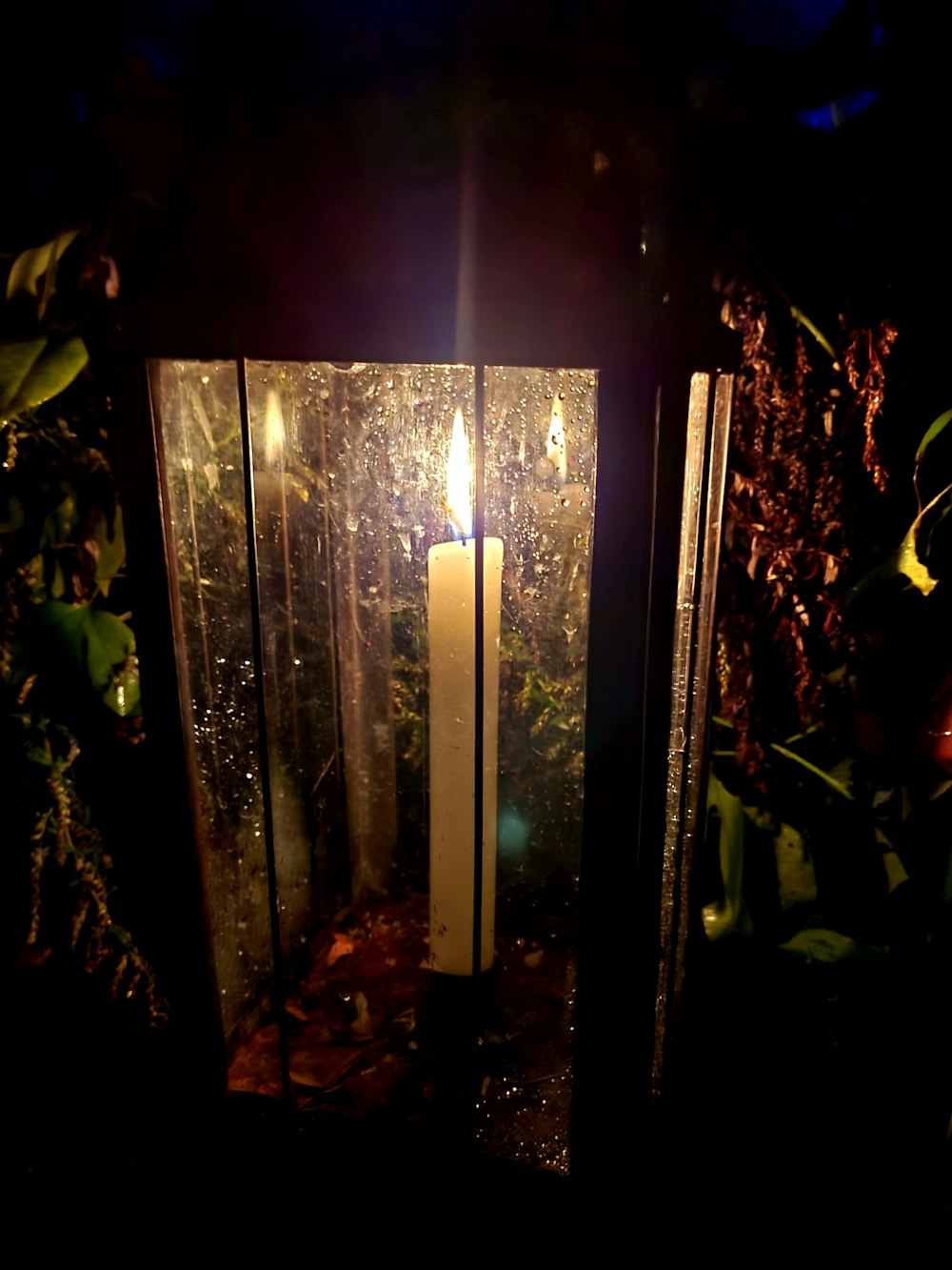 a lit candle sitting inside of a glass container