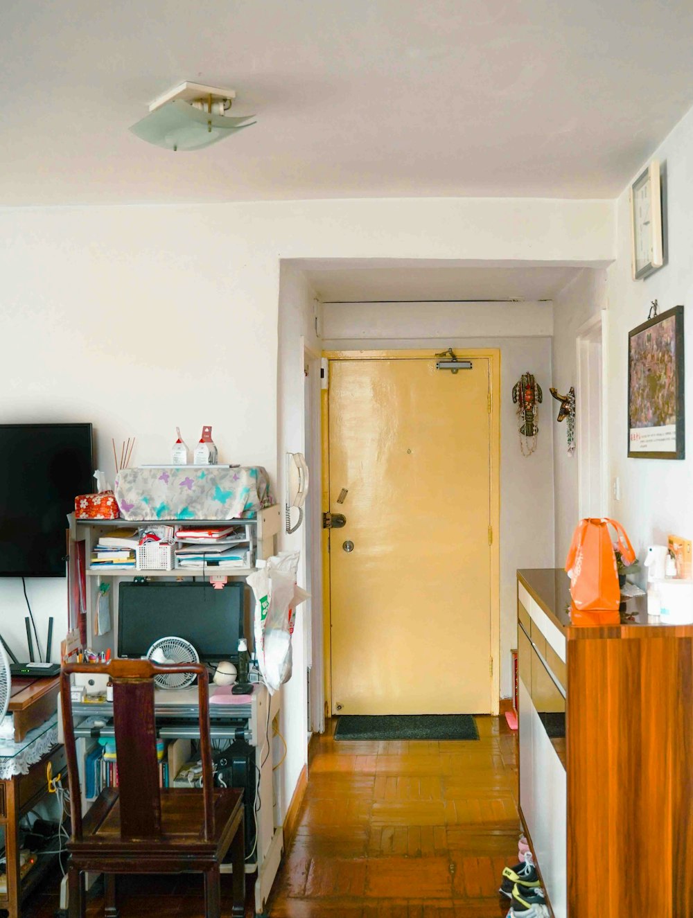 a room with a yellow door and a wooden floor