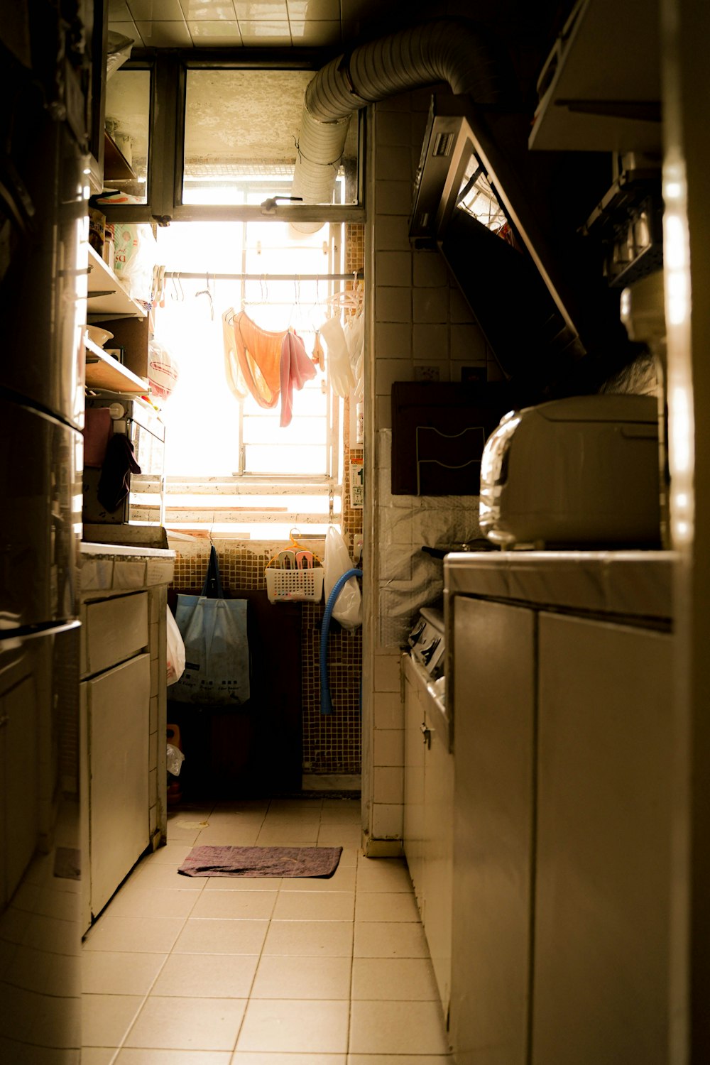 a kitchen with a stove, sink, cabinets and a window