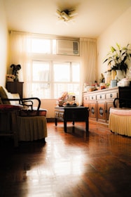 A cozy living room with a visible air conditioning unit, showcasing a comfortable environment.